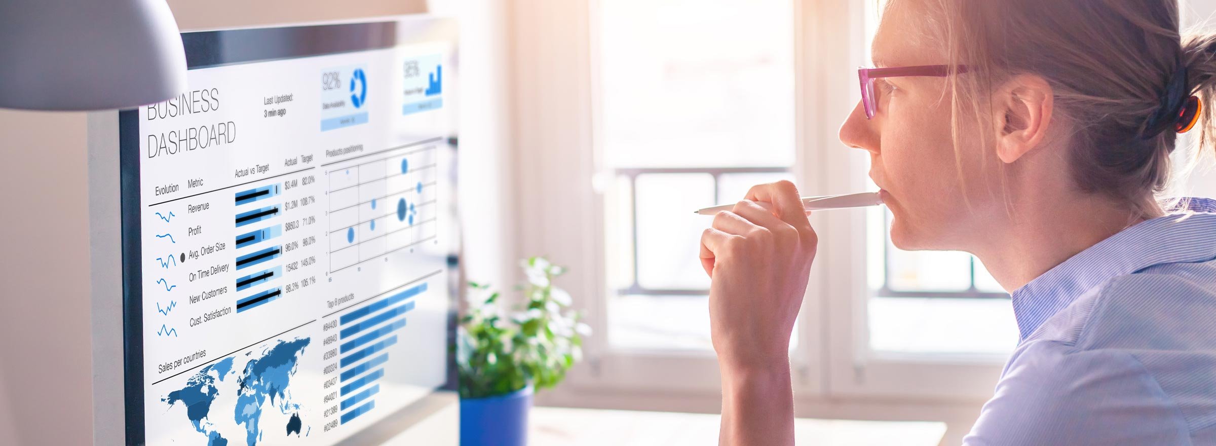 woman looking at a computer screen labeled Business Dashboard